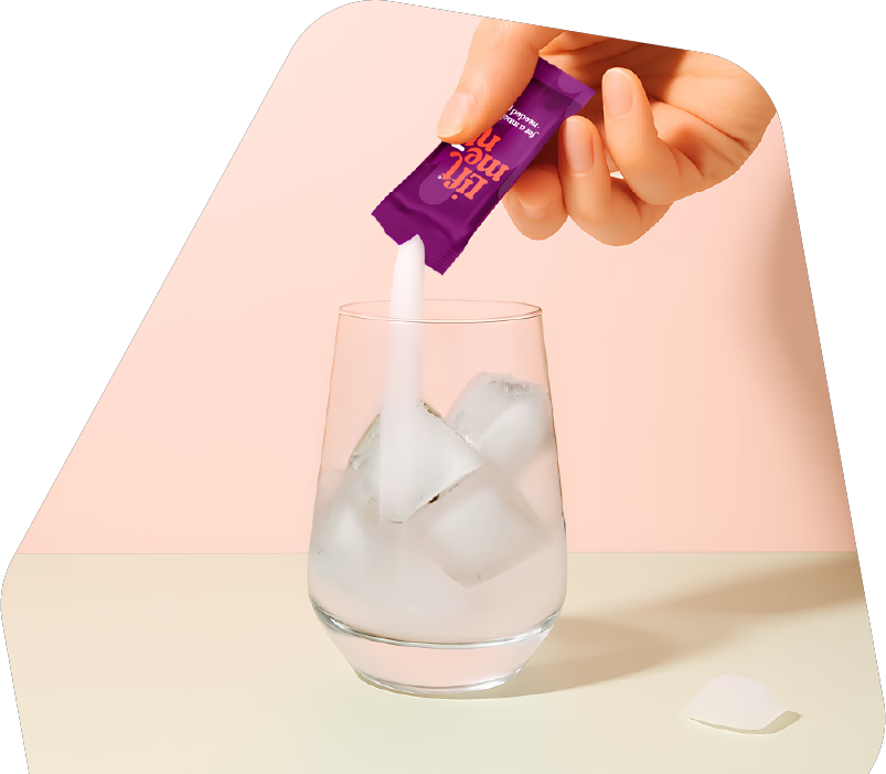 Liftment powder being poured into a glass of ice water